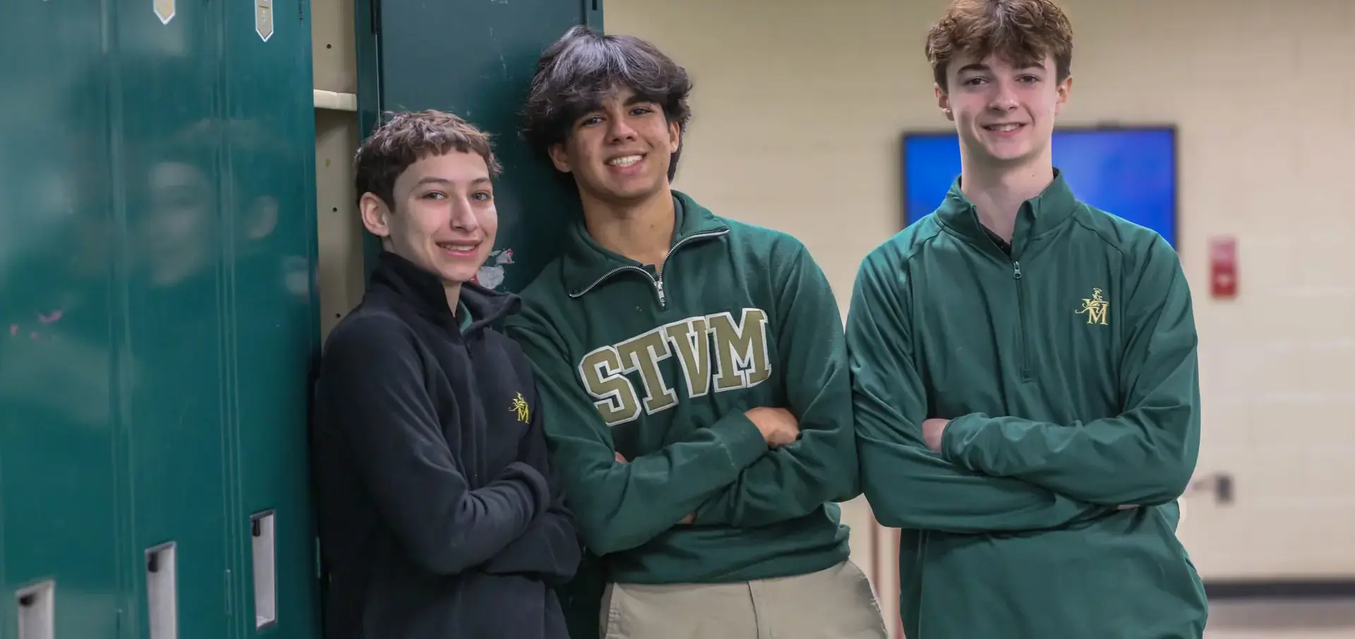 STVM students leaning against lockers, smiling, wearing STVM jumpers.