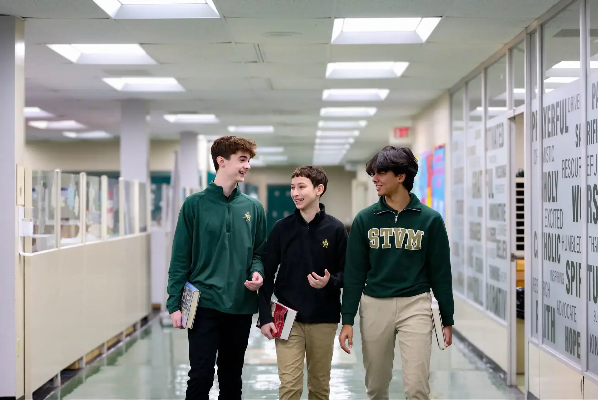 STVM students walking to class, carrying books and talking.