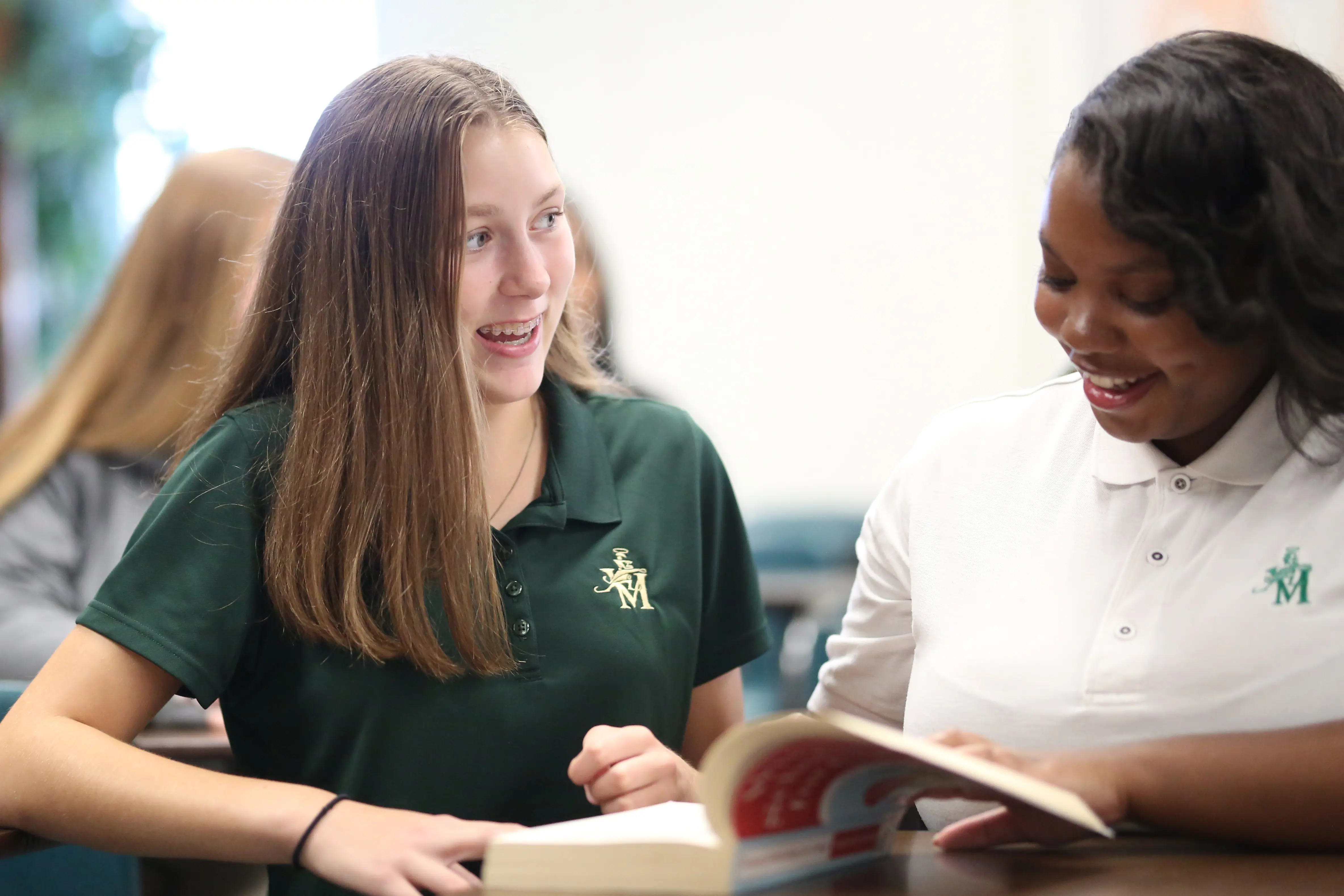St. Vincent-St. Mary High School students listening contemplatively in a science class.