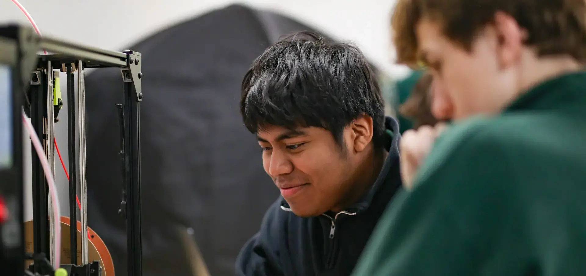 St. Vincent-St. Mary High School students working with a 3D Printer.