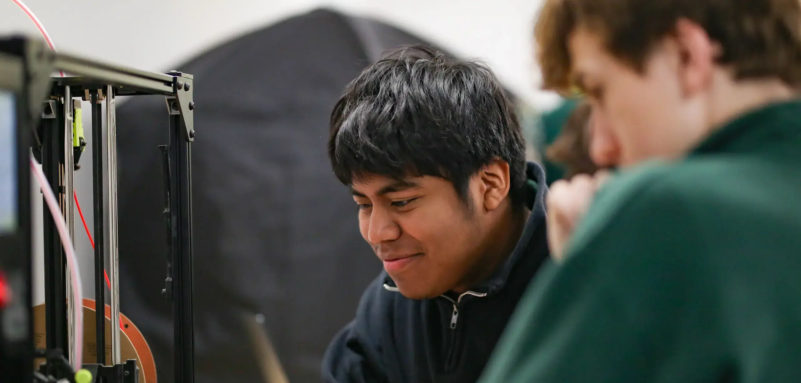 St. Vincent-St. Mary High School students working with a 3D Printer.