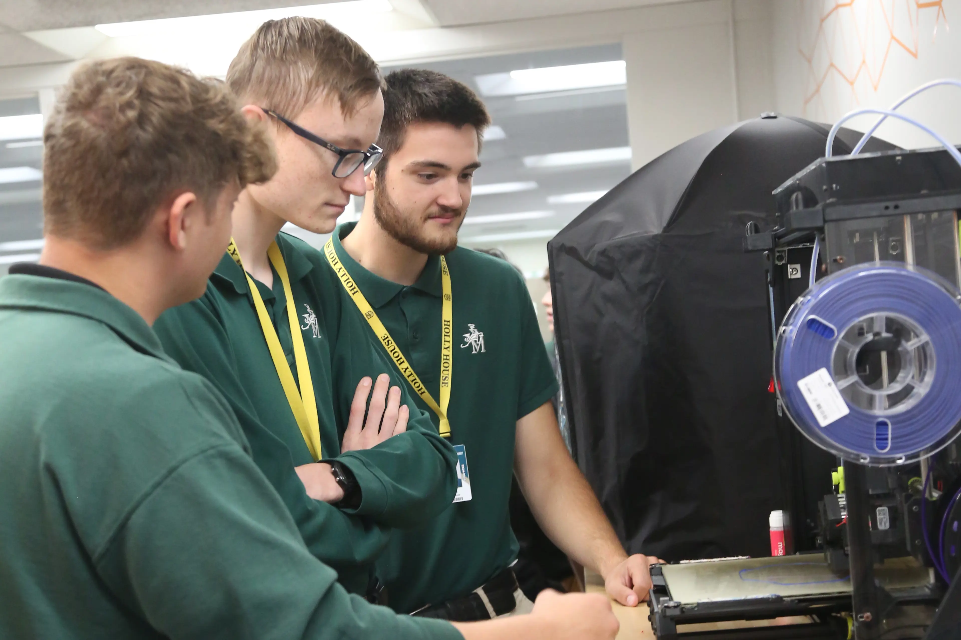 St. Vincent-St. Mary High School students working with a 3D Printer.