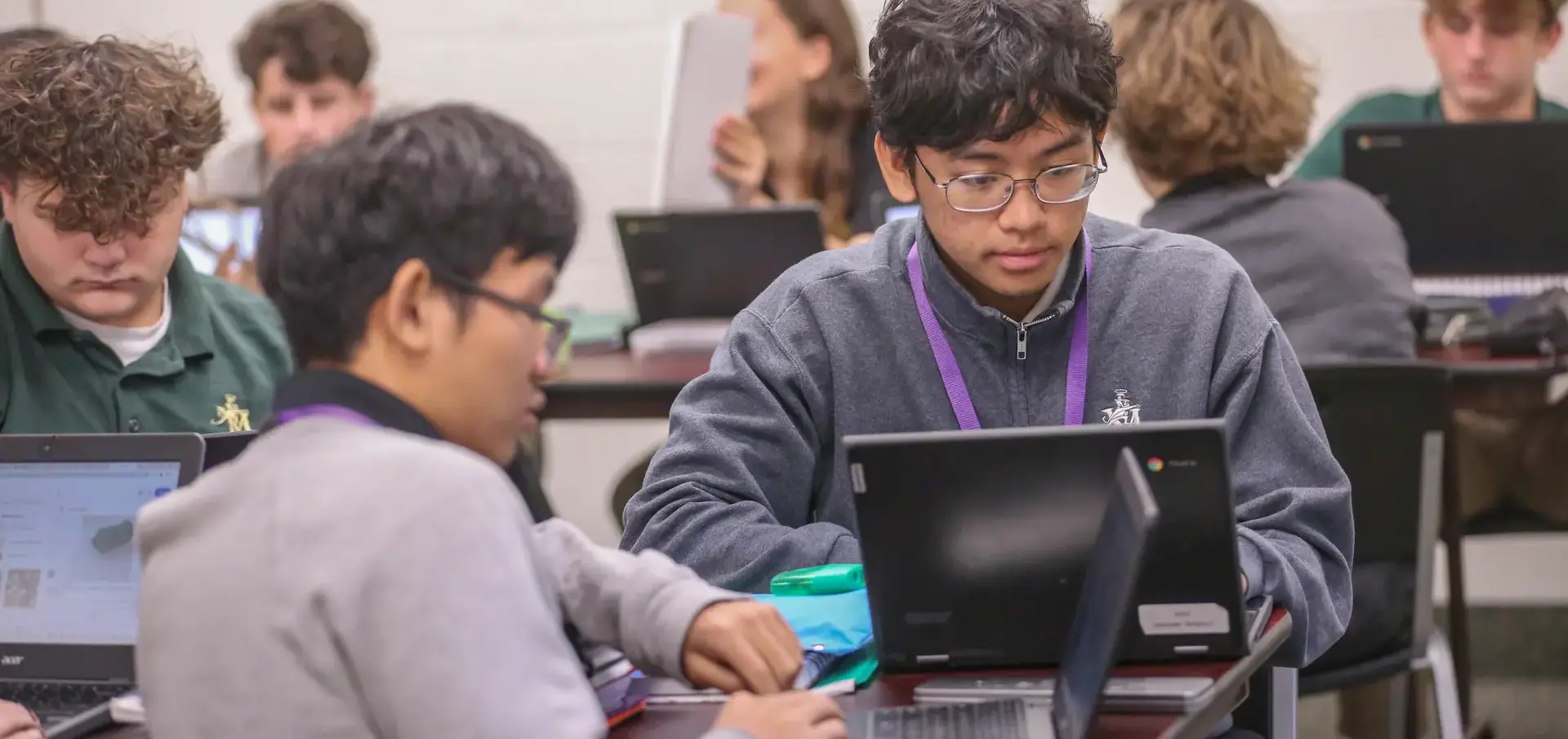St. Vincent-St. Mary High School students using computers in class, focused and engaged.