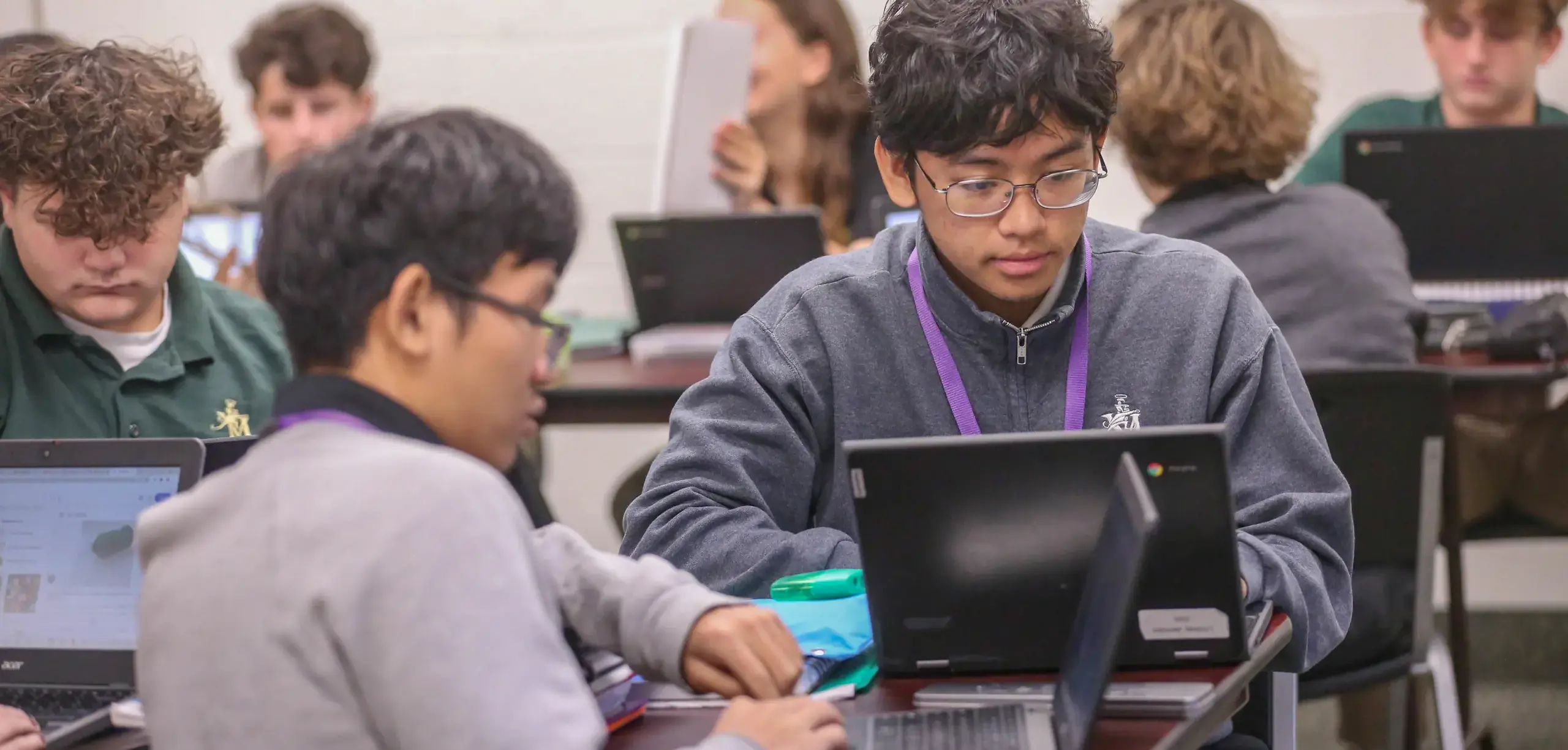 St. Vincent-St. Mary High School students using computers in class, focused and engaged.