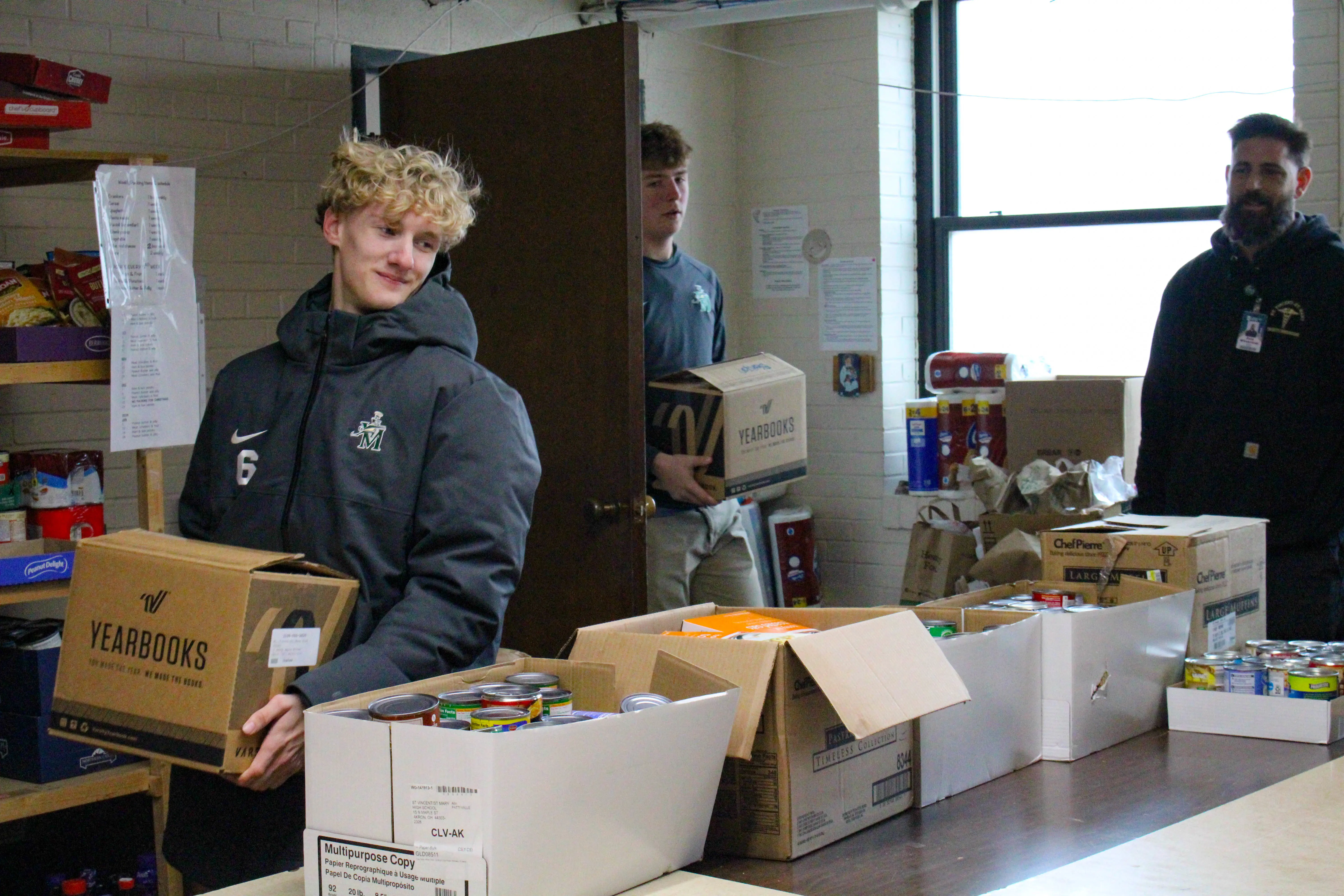 St. Vincent-St. Mary High School students dropping off cans to a food pantry.