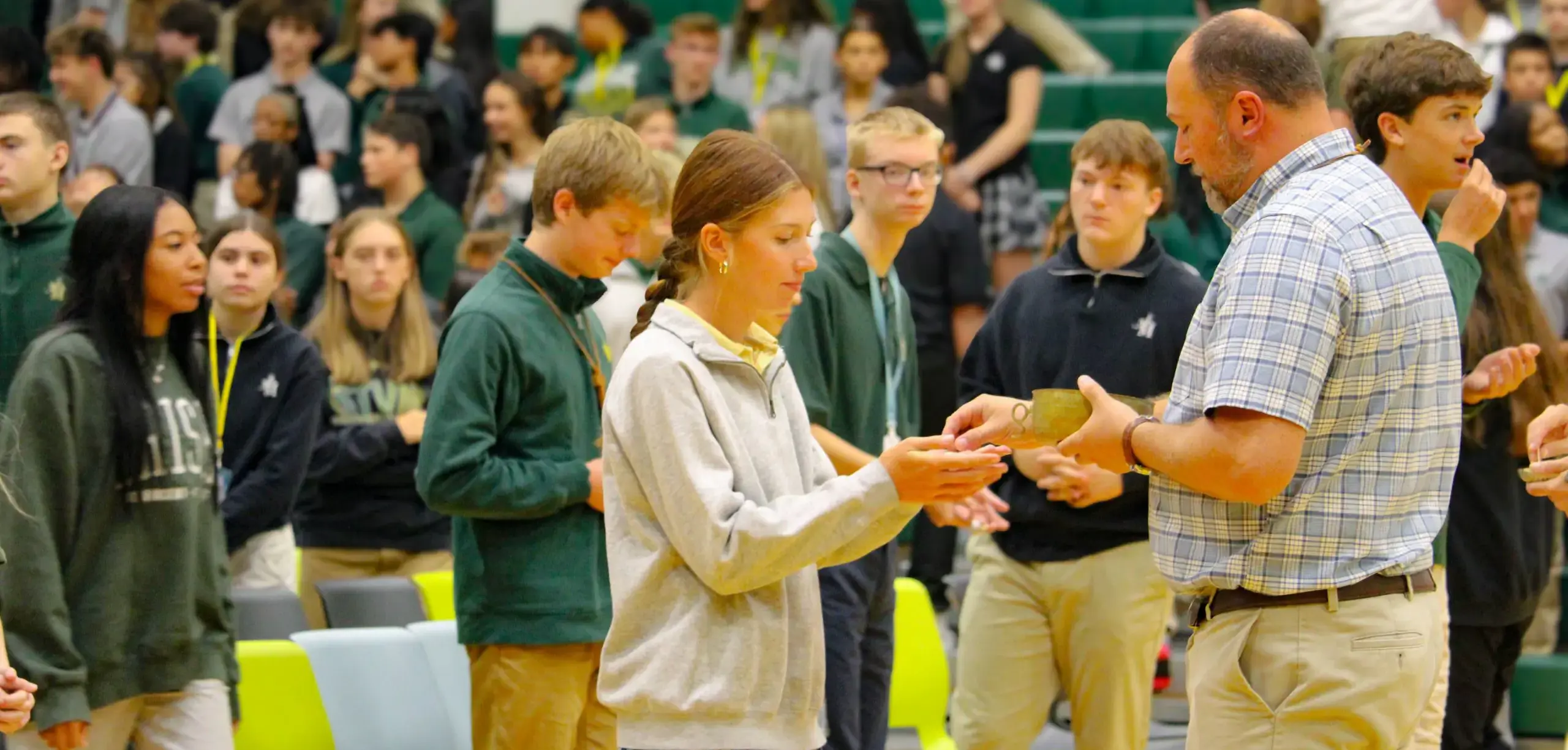 St. Vincent-St. Mary High School student receiving communion during a mass.