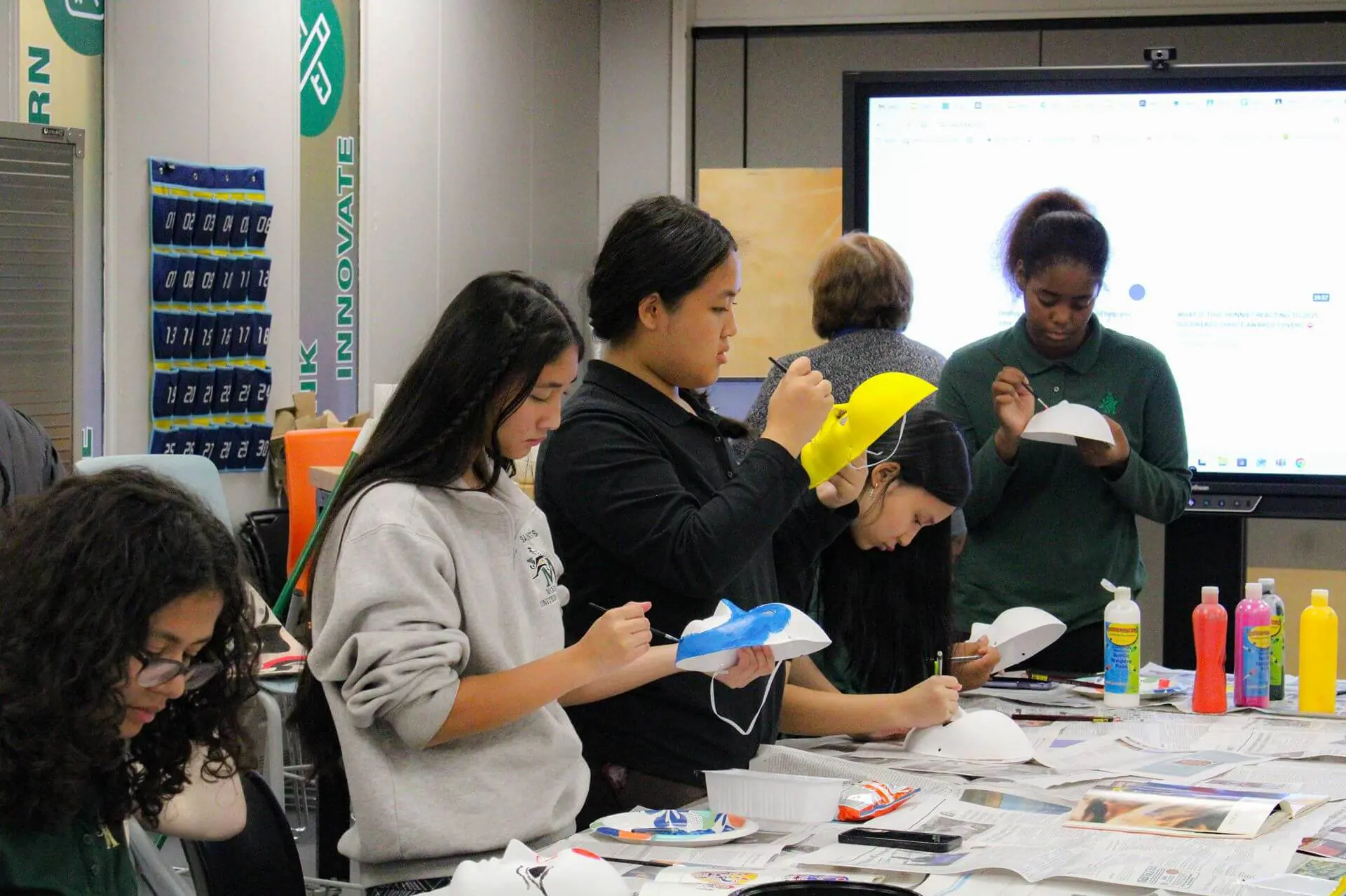 STVM students painting masks in an art class.