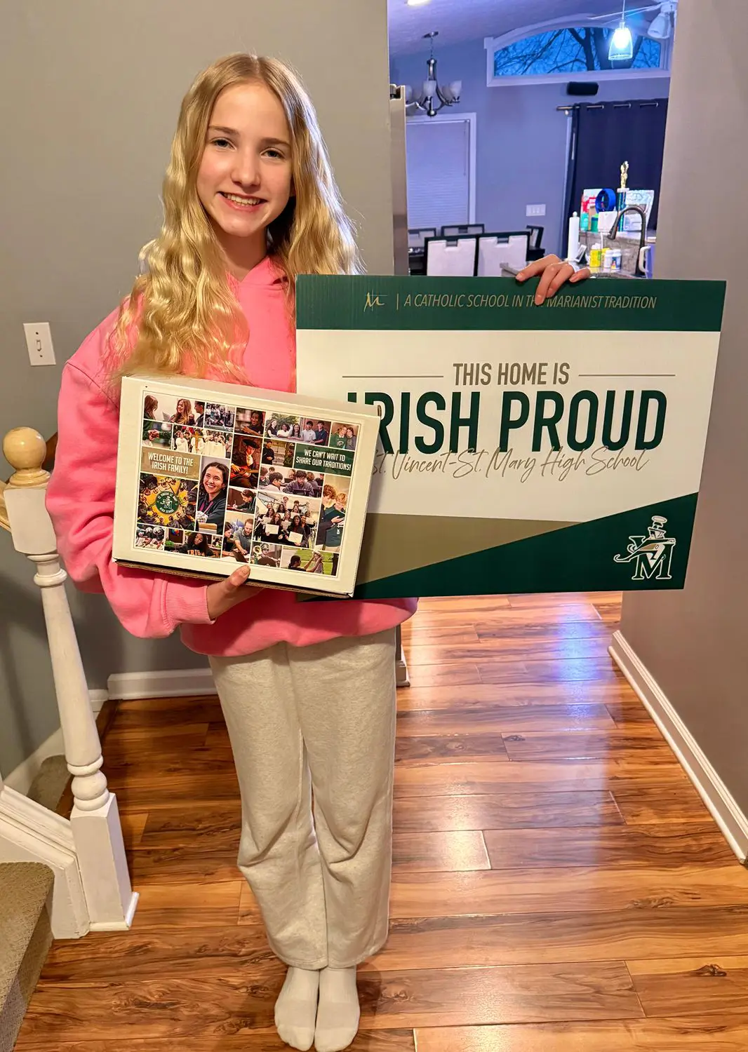 St Vincent St Mary High School student at their home holding a sign reading 'This Home is Irish Proud'.