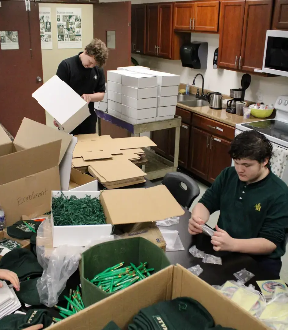 St. Vincent-St. Mary High School students packing boxes.