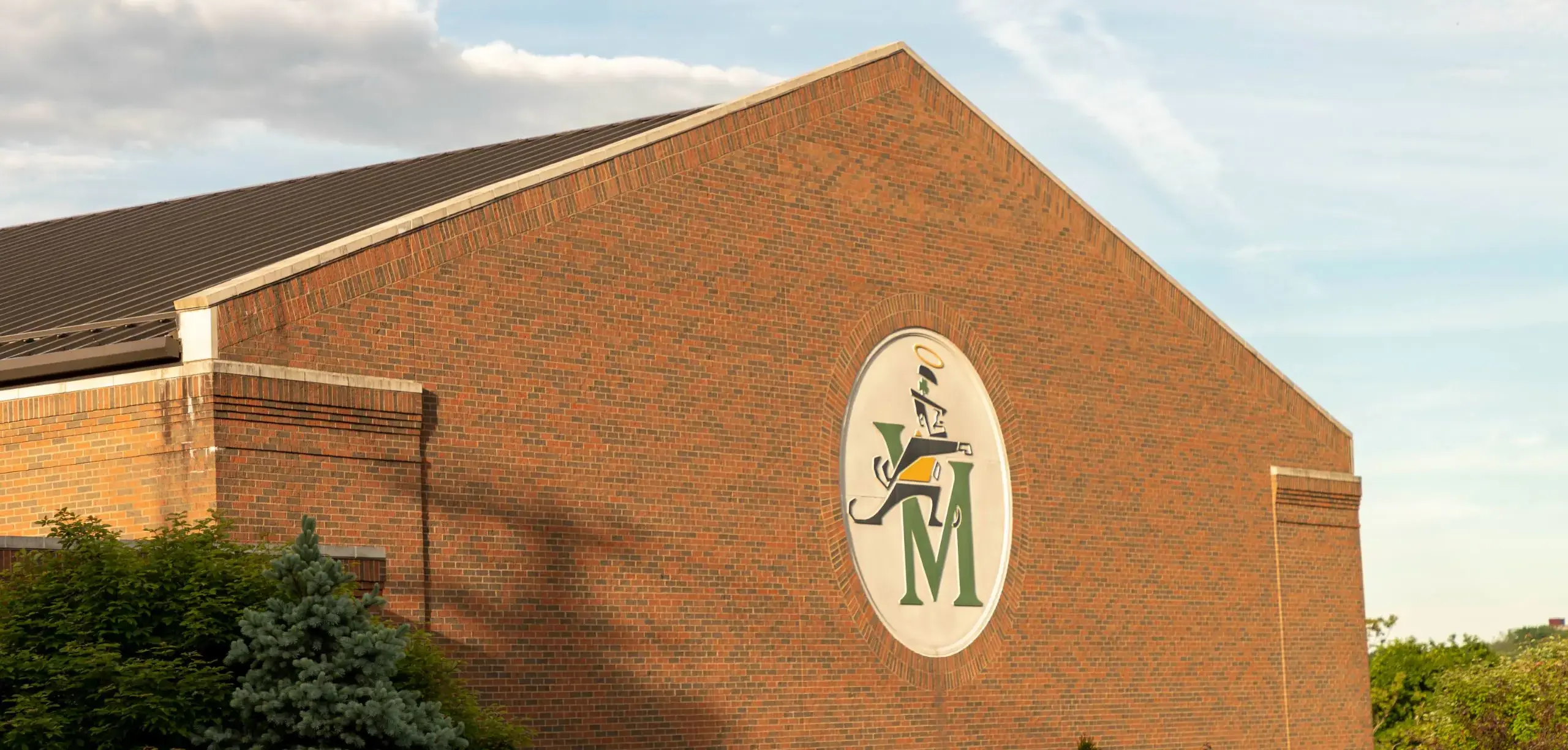 St. Vincent-St. Mary High School building with school badge decorating the wall.