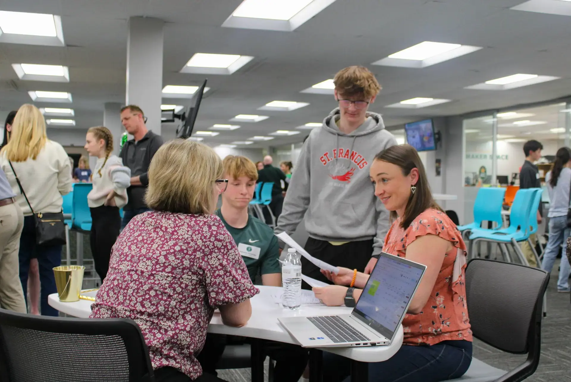 STVM teacher talking to parents at a parent session.