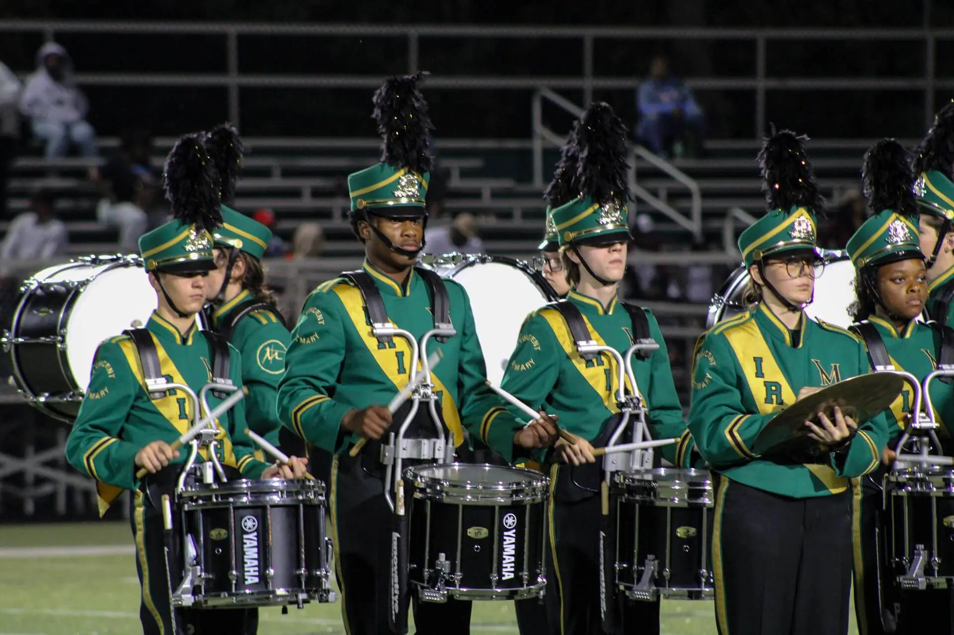 STVM marching band members playing drums at a game.