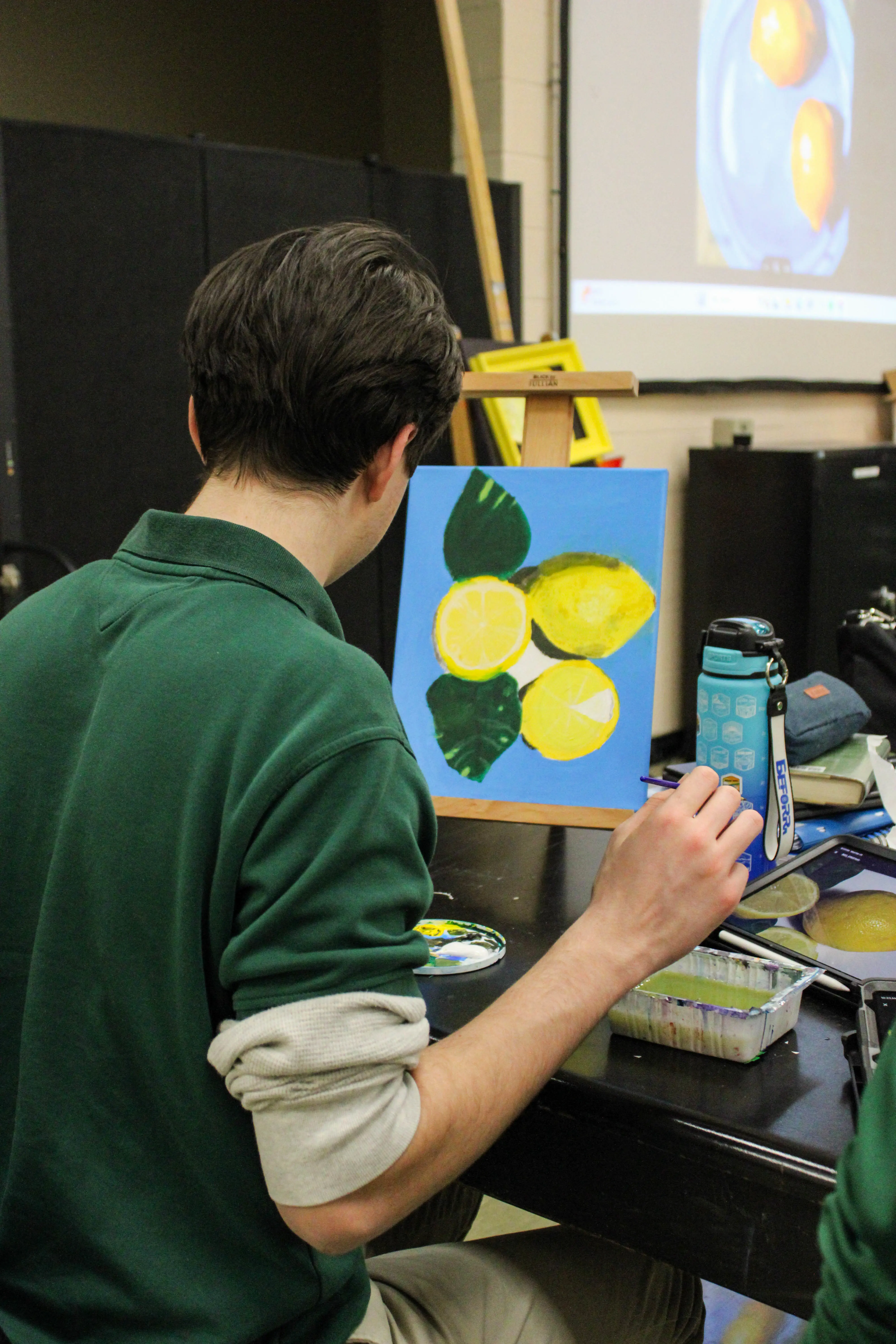 STVM student painting lemons in an art class.