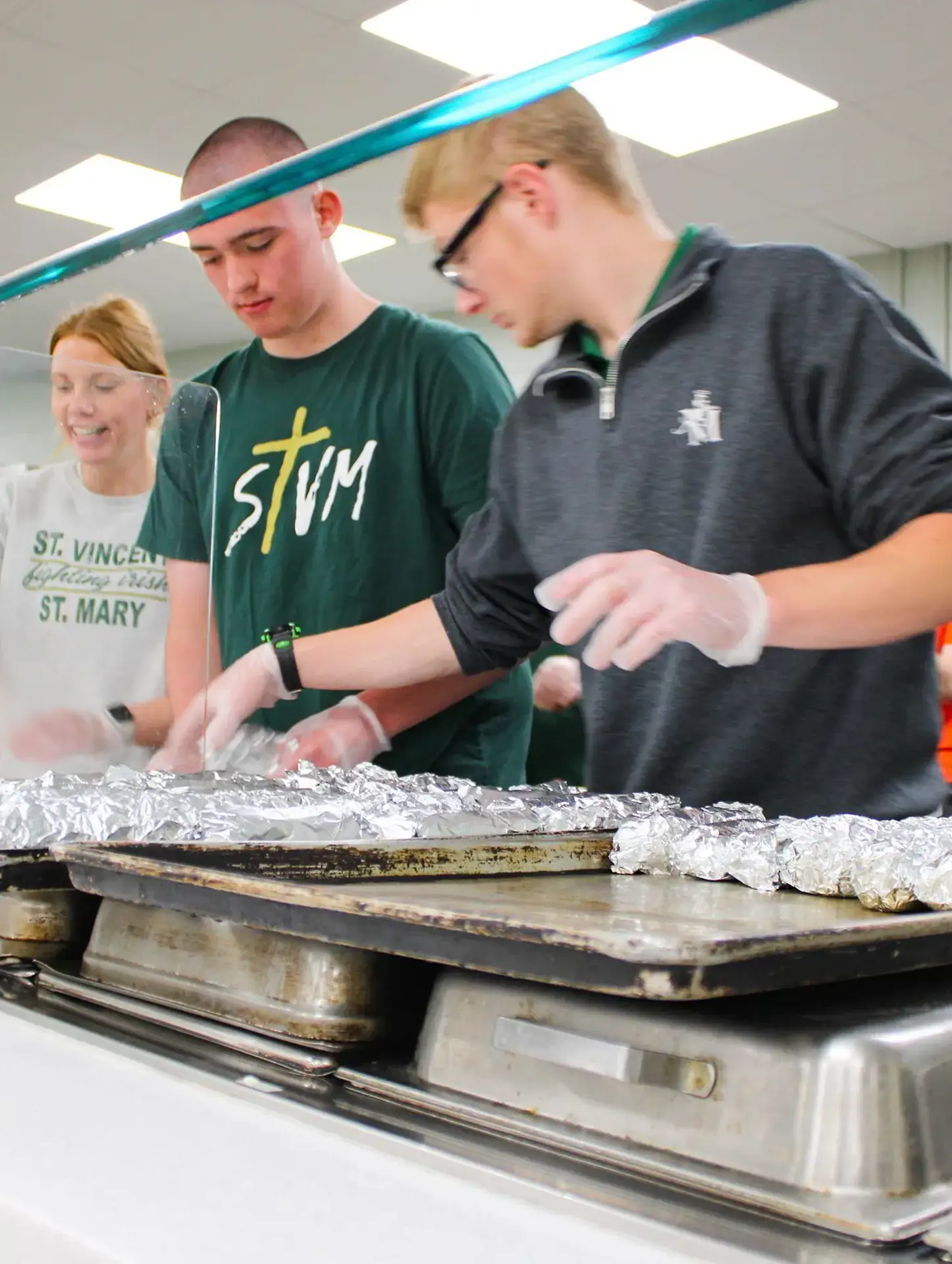 St. Vincent-St. Mary High School students serving food.