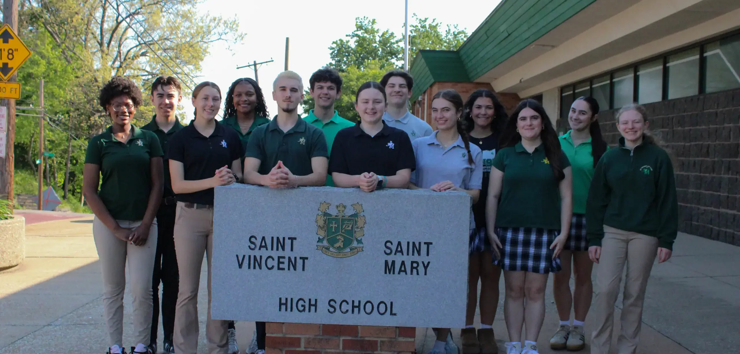 STVM Student Leadership with school sign.