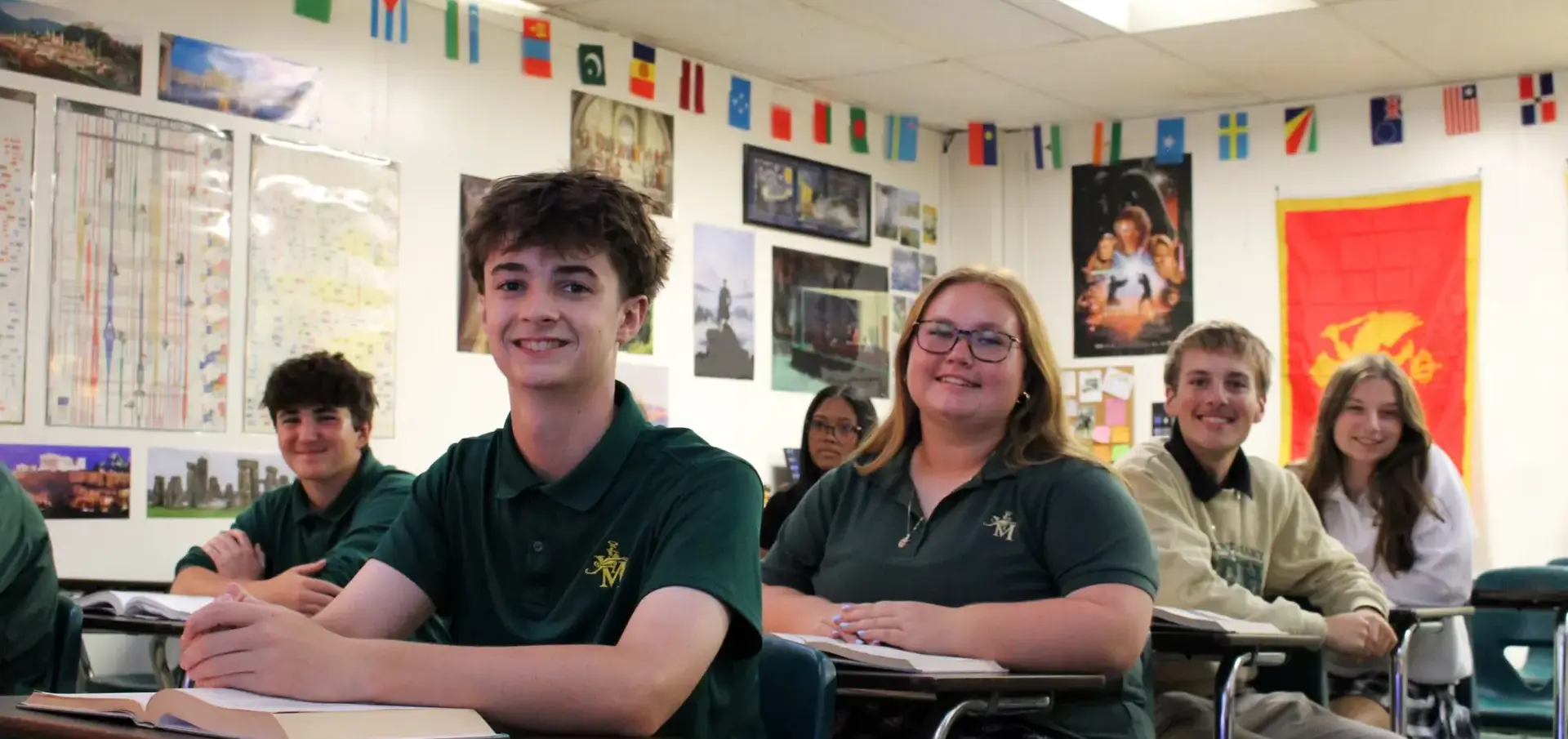 St. Vincent-St. Mary High School students smiling happily in class.