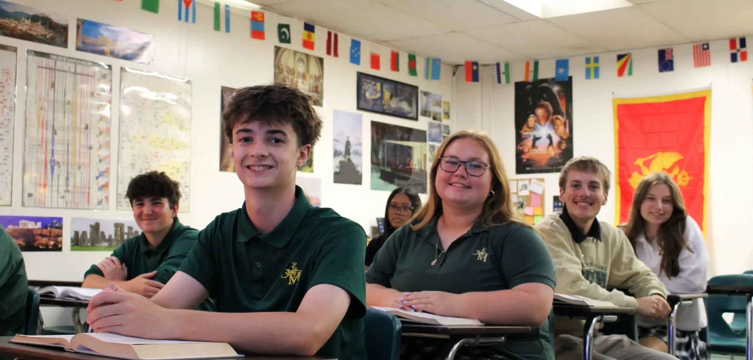 St. Vincent-St. Mary High School students smiling happily in class.
