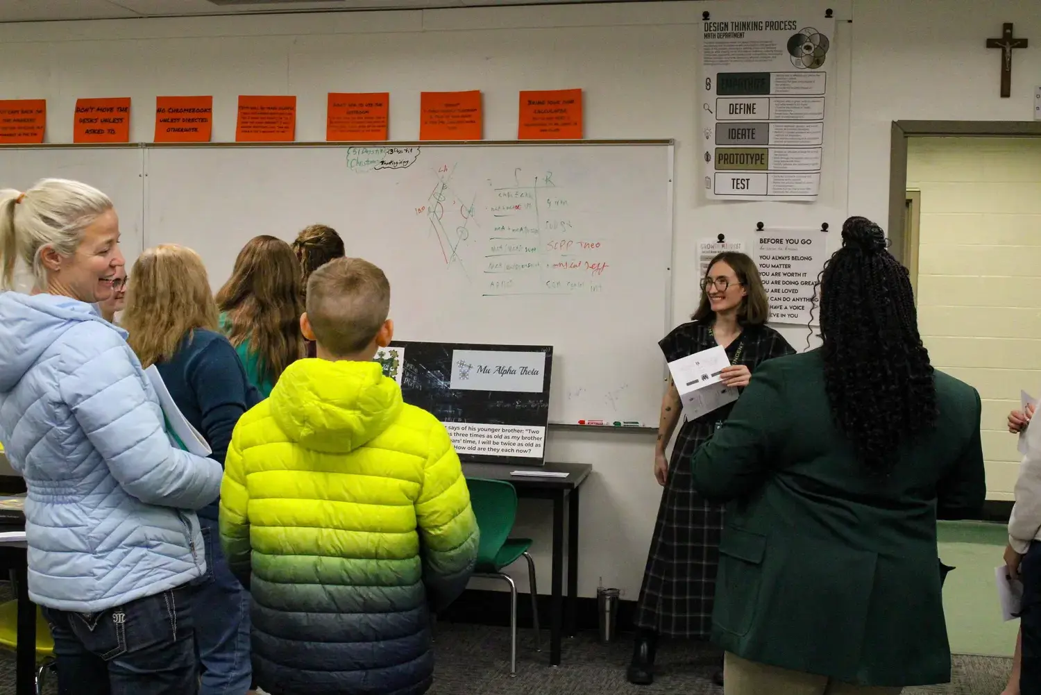 STVM students standing with parents in a classroom