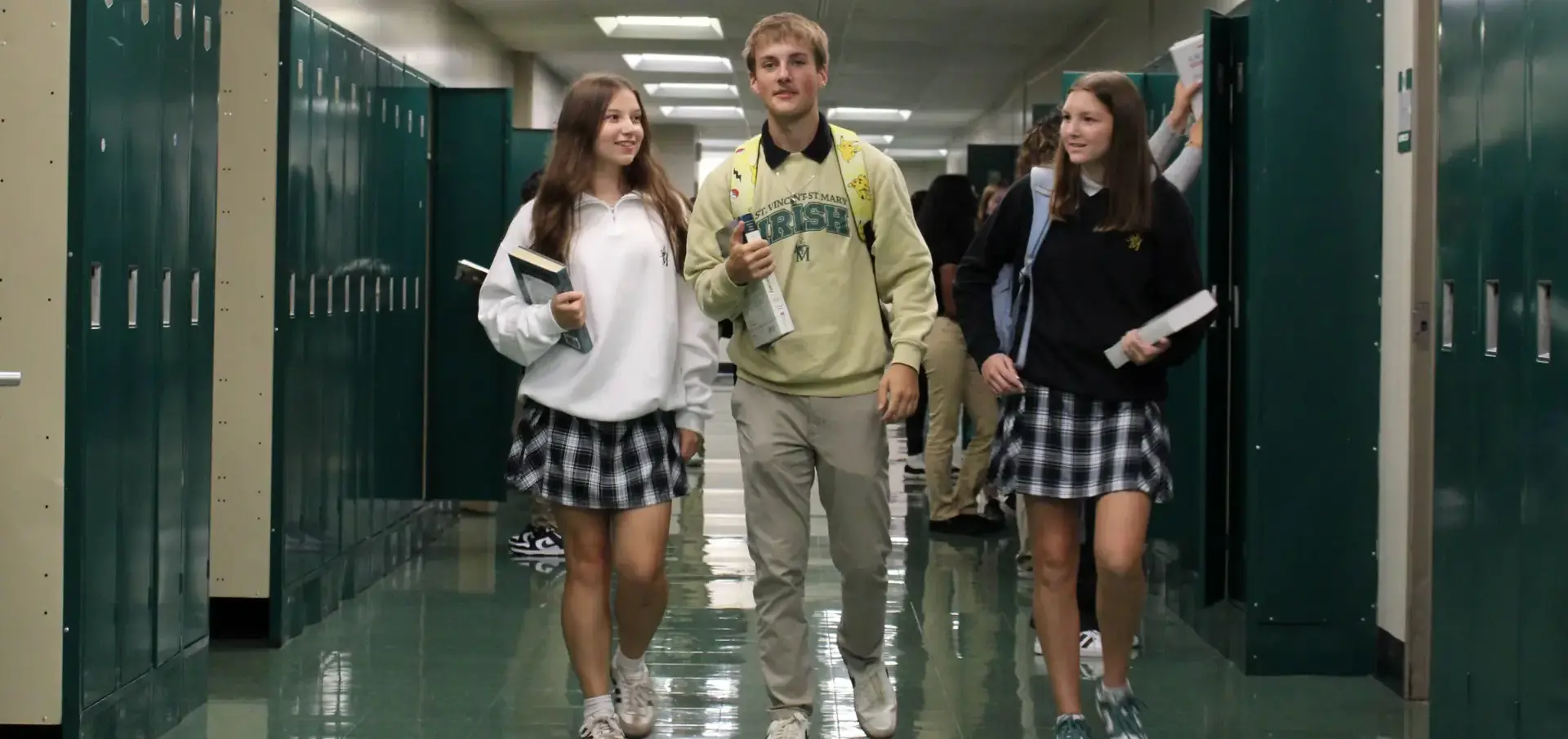 St Vincent St Mary High School students walking to class together, talking, laughing, in school uniform.