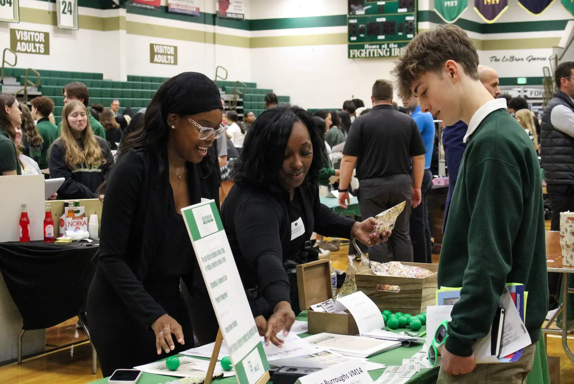 STVM student talking to representatives at a careers fair event.