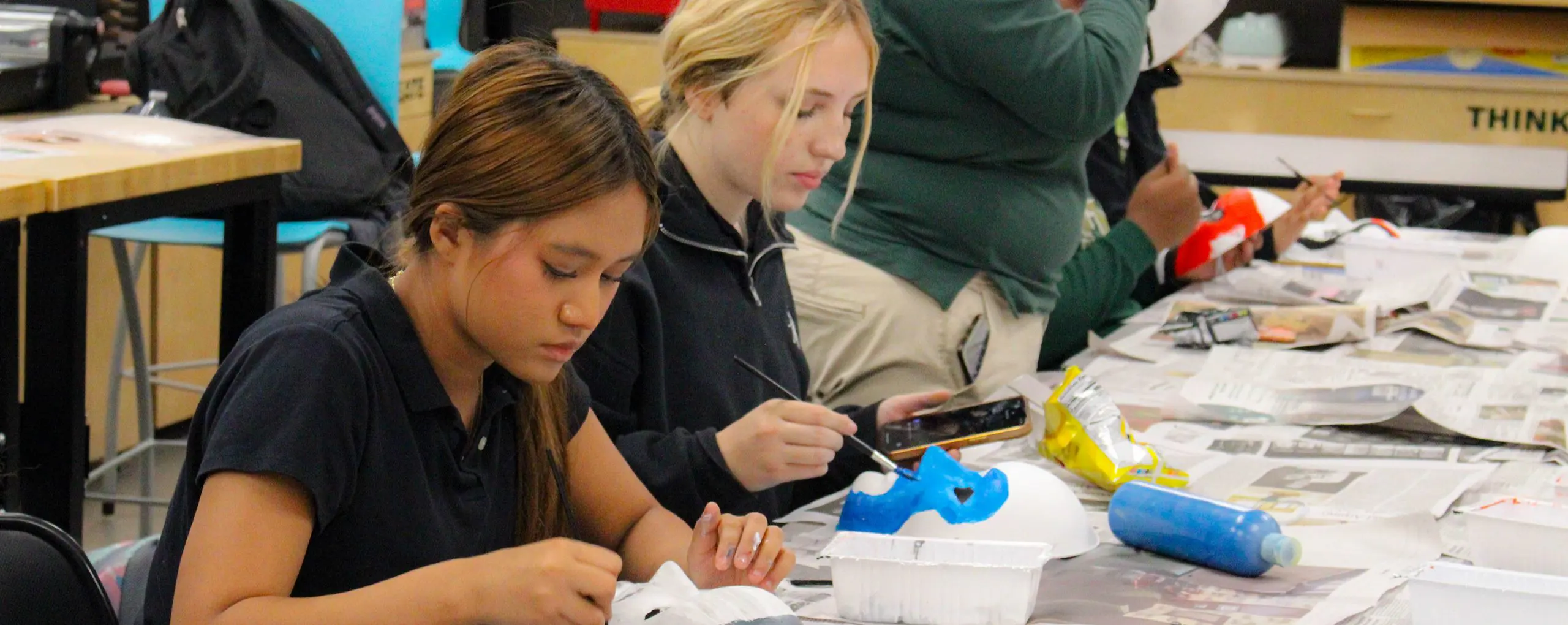 St Vincent St Mary High School students painting masks in an art class.