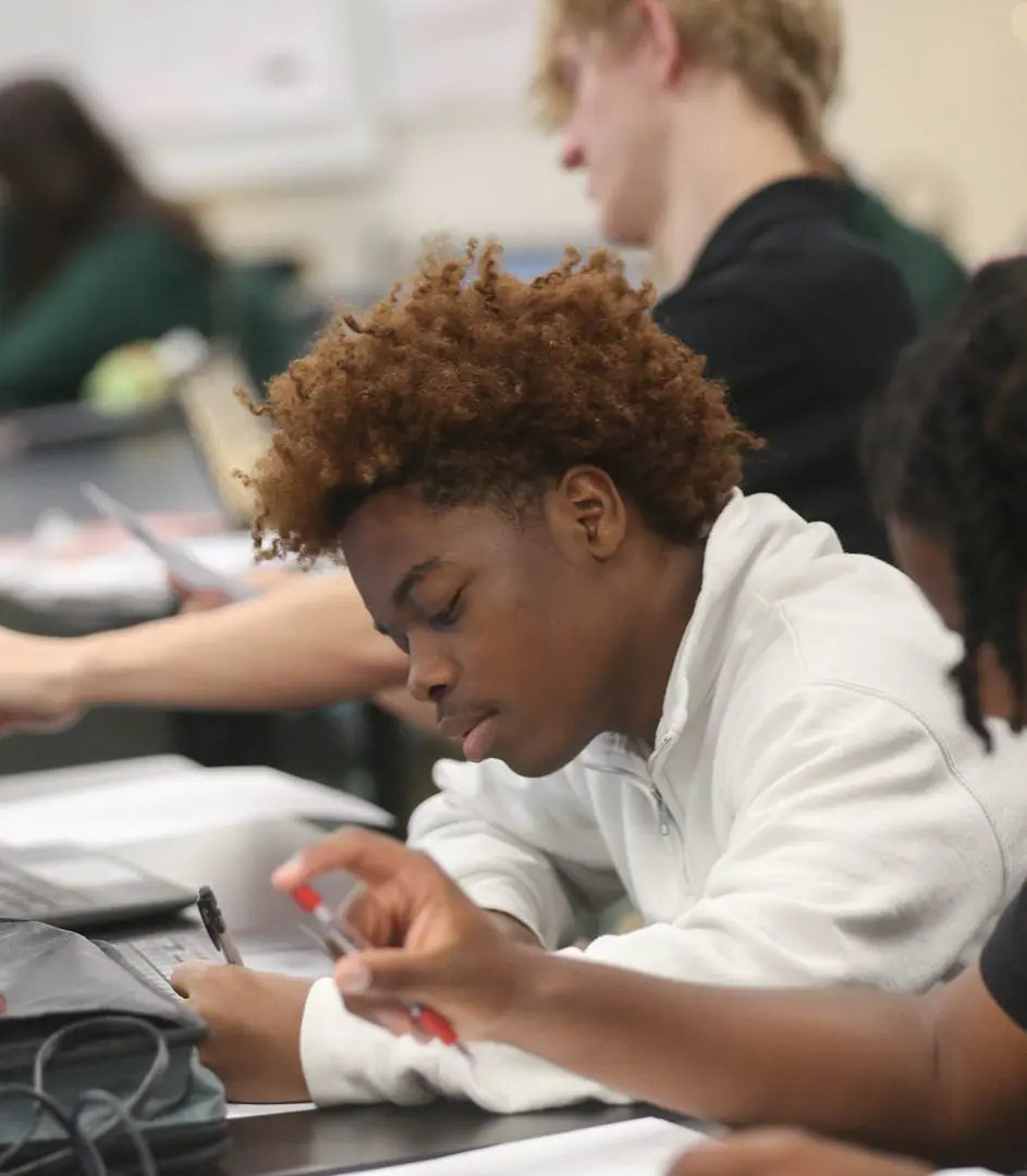 STVM student making notes in class.