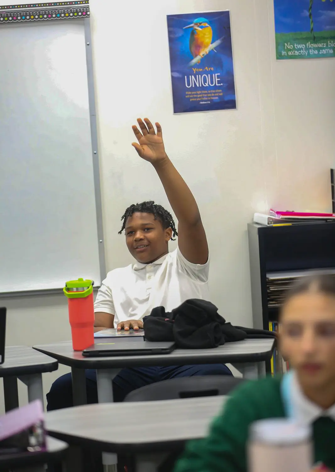 St Vincent St Mary High School student raising their hand in class.