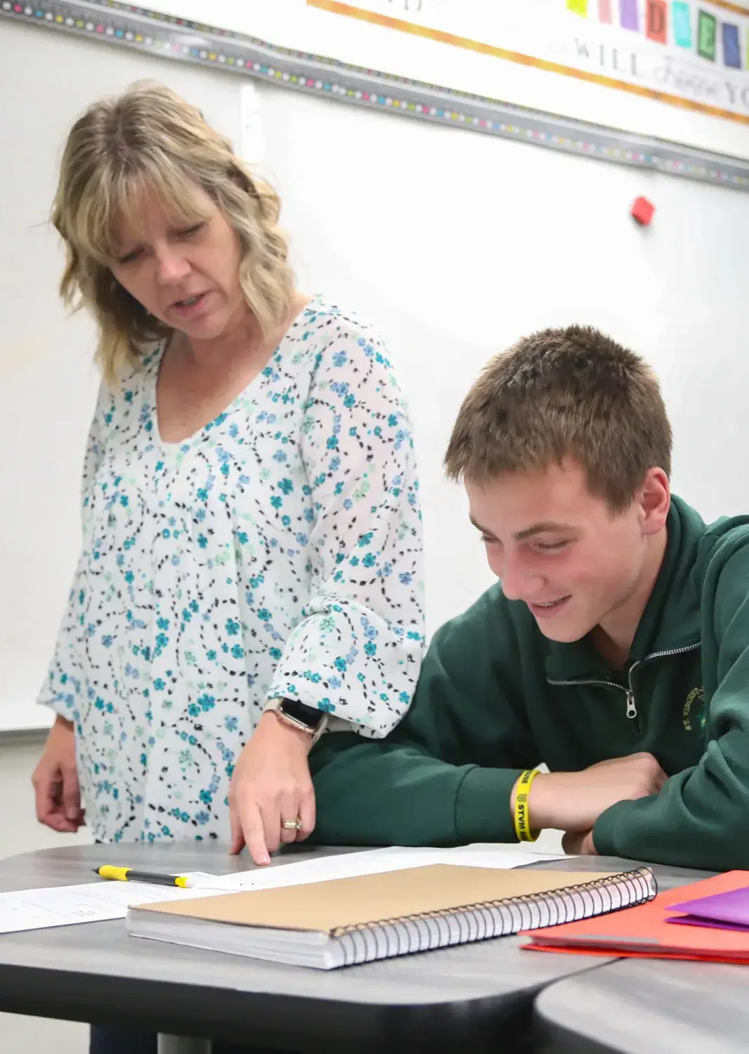 St Vincent St Mary High School teacher helping a student with classwork.