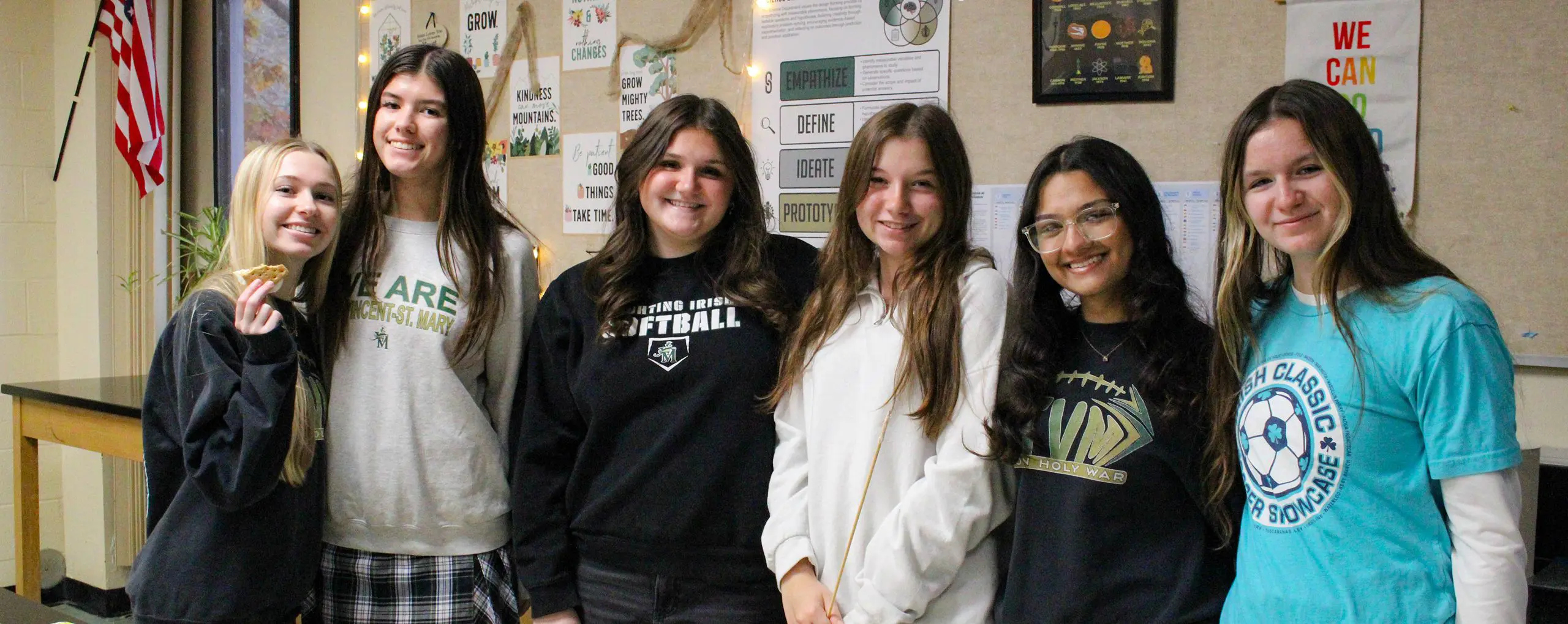 St Vincent St Mary High School students smiling happily, arm in arm.