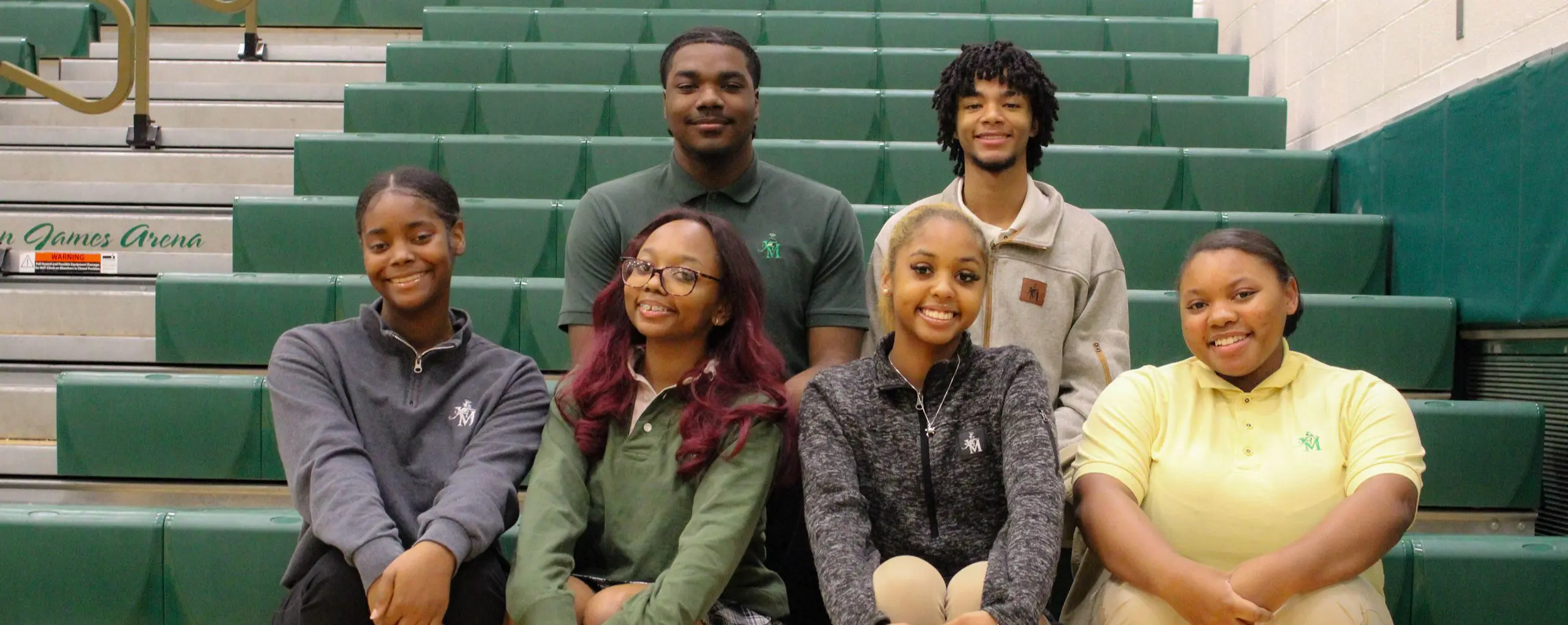 St Vincent St Mary High School students sitting together, smiling cheerfully.
