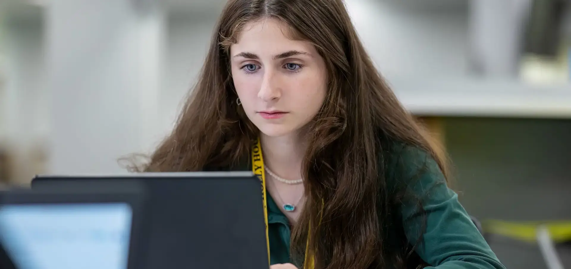 St Vincent St Mary High School student completing classwork on a laptop.
